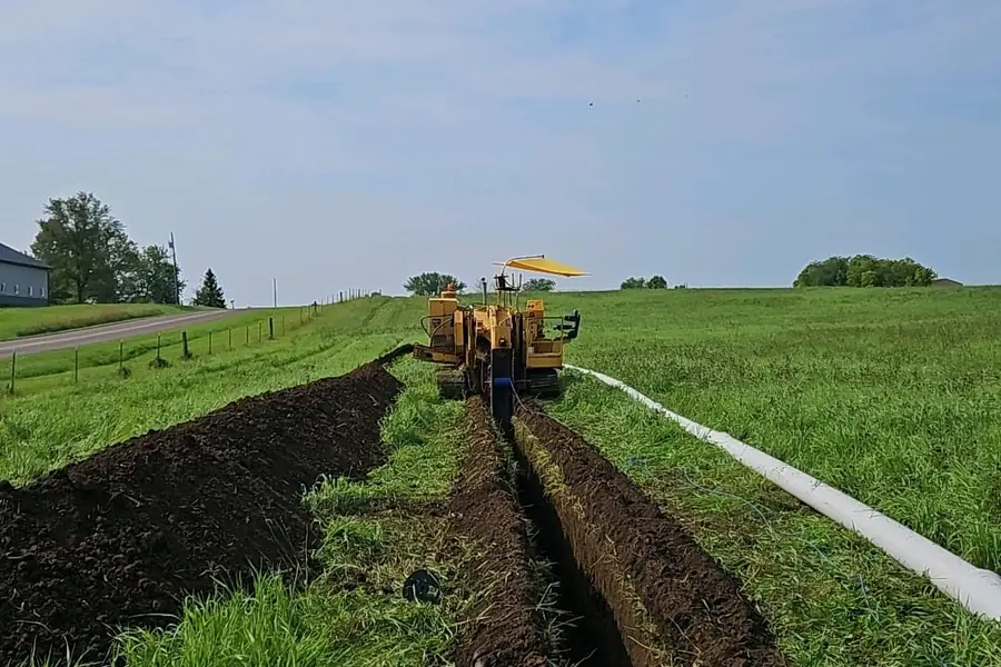 Long-run trenching with pipe staged along the cut